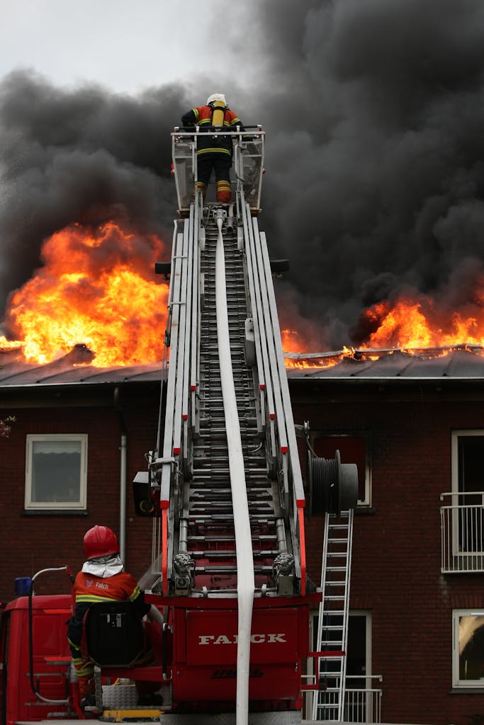 Heroic firefighters tackle a fierce blaze on a city home, using a ladder truck.